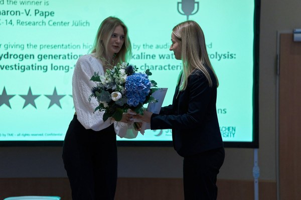 Sharon Pape (right) is awarded for her presentation.